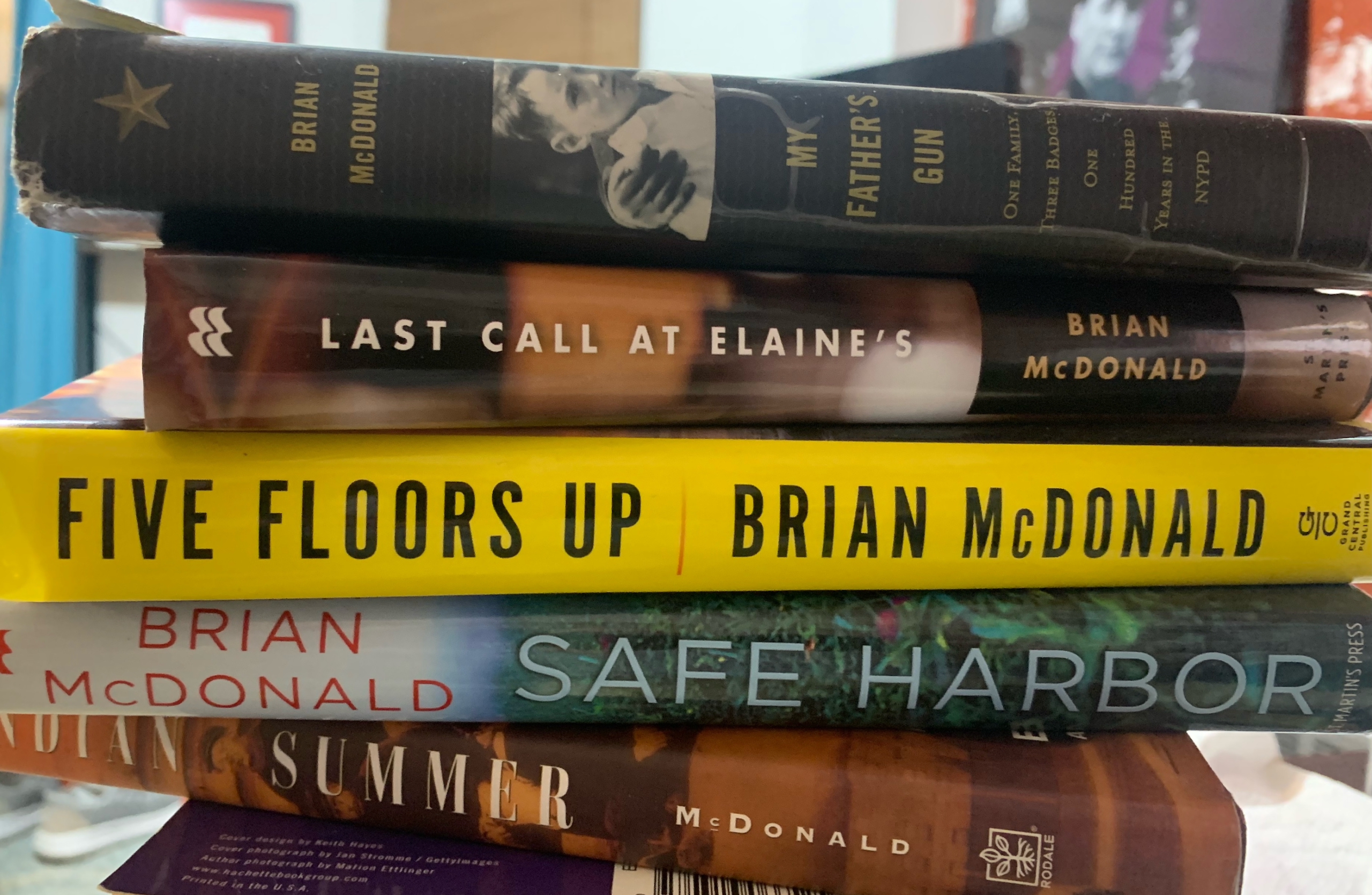 Stack of books by Brian McDonald including My Father's Gun, Last Call at Elaine's, Five Floors Up, Safe Harbor, and Summer.